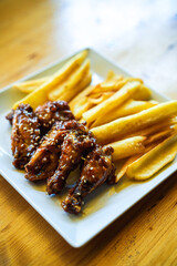 Chicken wings and legs with French fries