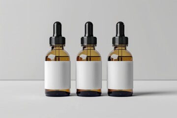 Three dropper bottles with blank labels depicted in a mock up