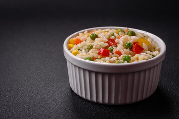 Delicious white boiled rice with vegetables, sweet peppers, carrots, peas