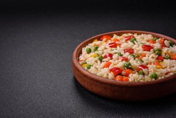 Delicious white boiled rice with vegetables, sweet peppers, carrots, peas
