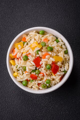 Delicious white boiled rice with vegetables, sweet peppers, carrots, peas