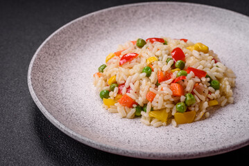 Delicious white boiled rice with vegetables, sweet peppers, carrots, peas