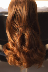 Detailed view of shiny auburn hair highlighting its natural waves and texture background © Parilov