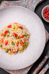 Delicious white boiled rice with vegetables, sweet peppers, carrots, peas