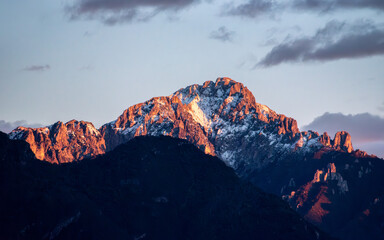 Sunset at snowcapped mount Grigna at lake Como