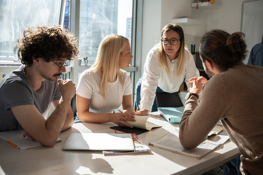 A Language Professor Instructs Students In Foreign Language At A Diverse Language School.	