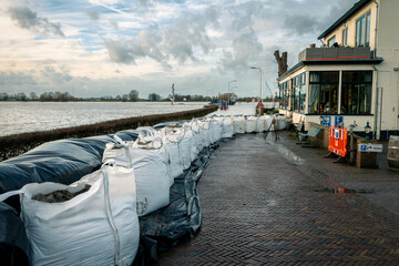 Sandbags for the houses in the village of Olst to prevent flooding due to the excessive rainfall and the rising water due to climate change in the rain river the IJssel.