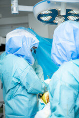 Professional hospital operation process. Sterile surgery uniform specialists working.