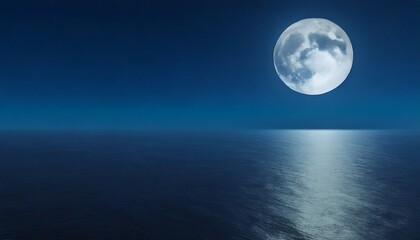 full moon rising over empty ocean at night with copy space