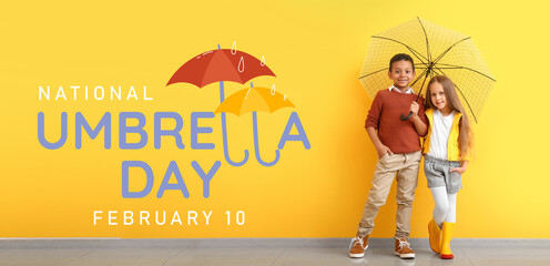 Fashionable little children in autumn clothes and with umbrella near color wall © Pixel-Shot