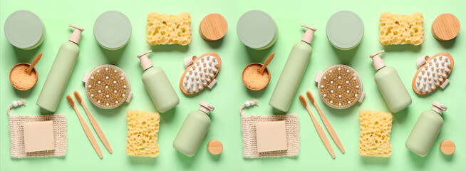 Set of bathing cosmetics and supplies on green background, top view