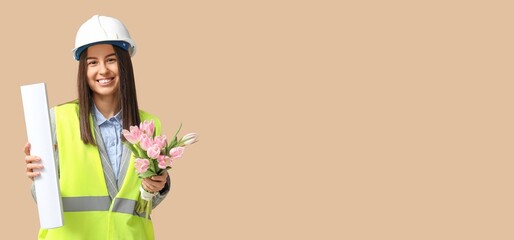 Beautiful architect holding flowers on beige background with space for text. Women's Day celebration