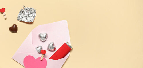 Chocolate candies and envelope on yellow background with space for text. Valentine's Day celebration