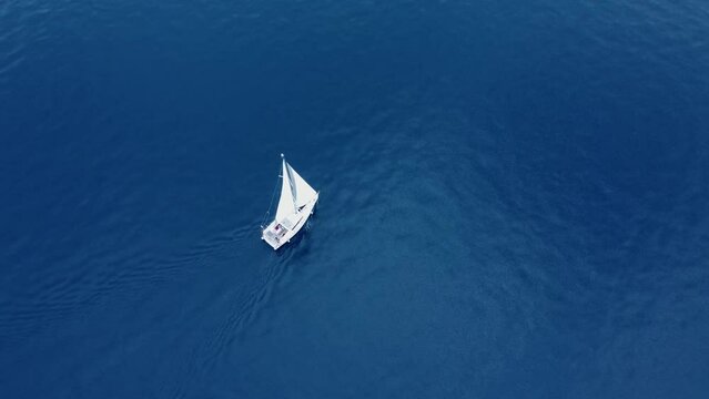 Sailboat in the sea during the summer aerial shot 4k. This shot is about sailboat in the blue sea of Greece during the summer, the vacations and travel in Greece, minimal shot