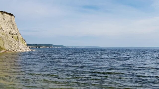 Beautiful summer view of Stepan Razin Rock on the Volga River, Saratov region, Russia. An amazing landscape with blue sky, steep cliffs and picturesque mountains with a white road. 4K