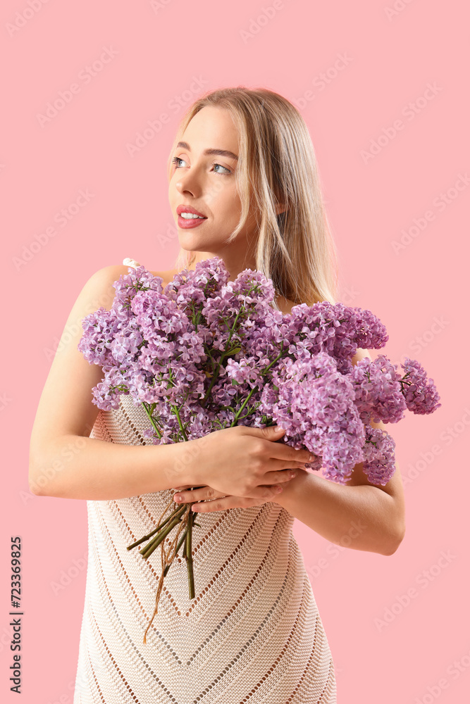 Poster Young woman with lilac flowers on pink background