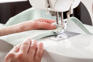 Sewing machine, stitching fabrics, needle in a round plan