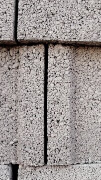 Close-up of blocks at construction site, pumice stone blocks packed on cubic pallets. Construction site features stack of pumice blocks, detailed view of block arrangement. Blocks showcased in detail
