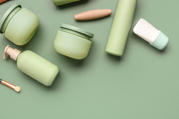 Composition with different cosmetic products on green background