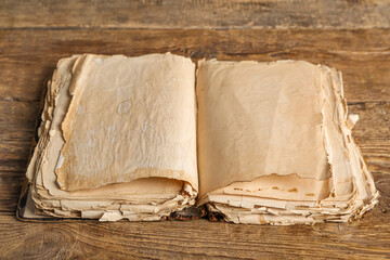 Open old book on wooden background