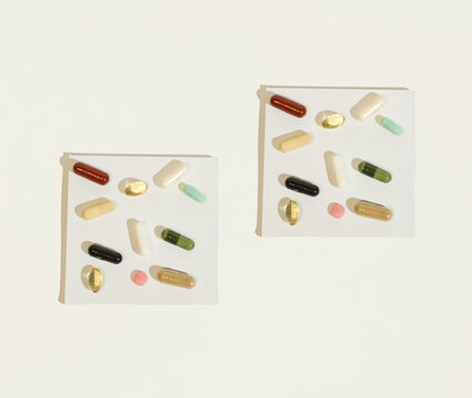 Pills and supplements on a white background. Minimal medical concept.Copy space. Flat lay.