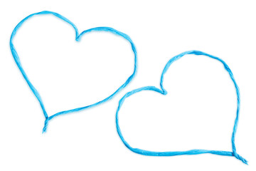 Heart made of thin twisted blue paper cut out on a blank background