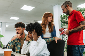 A multicultural team is having issues on new assignment at the office.