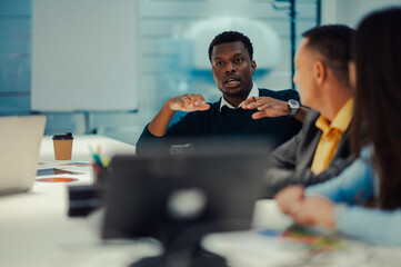 Portrait of an african american man talking during a meeting in a modern office