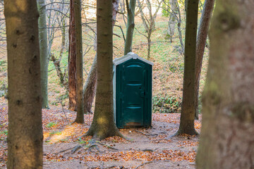 Green toilet cabin in the forest