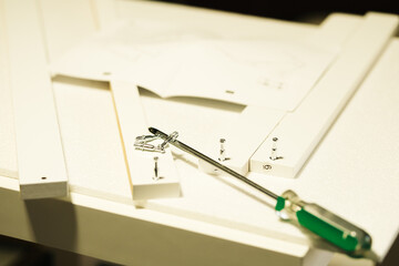 Home work center assembling furniture with tools.