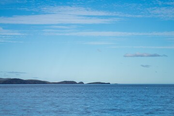 Obraz premium beautiful bruny island at dawn with pink clouds and the ocean below in australia
