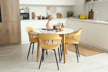 Interior of modern kitchen with table served for breakfast