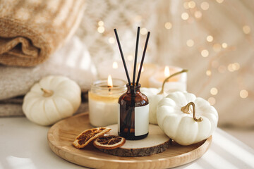 Still life details in the living room. Autumn composition with aroma diffuser with pumpkin pie...