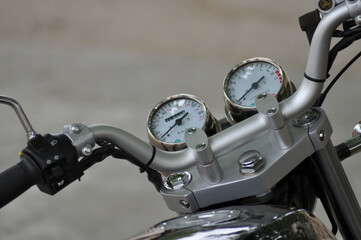 Part of motorcycle handle with a dashboard, speedometer and rev counter