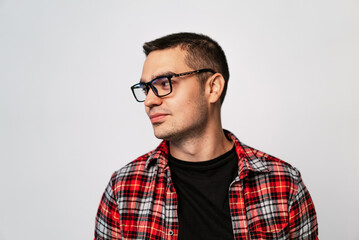 Portrait of young man in glasses and plaid shirt