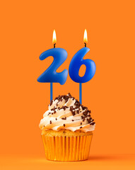 Blue candle number 26 - Birthday cupcake on orange background