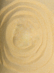 Fototapeta na wymiar Top view of beautifully lit and studio shot yellow beige desert sand with natural wave design