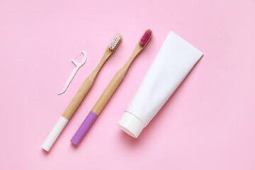 Toothbrushes, floss toothpick and toothpaste on pink background. World Dentist Day