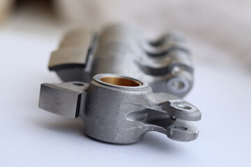 Aluminium alloy rocker arm with resist abrasion surface for contact with camshaft.