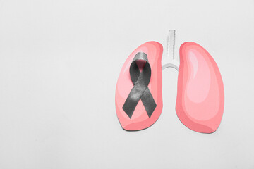 Paper lungs with ribbon on grey background