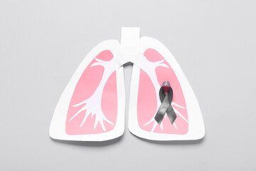 Paper lungs with ribbon on grey background