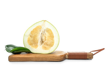 Wooden board with half of fresh pomelo fruit and leaves on white background
