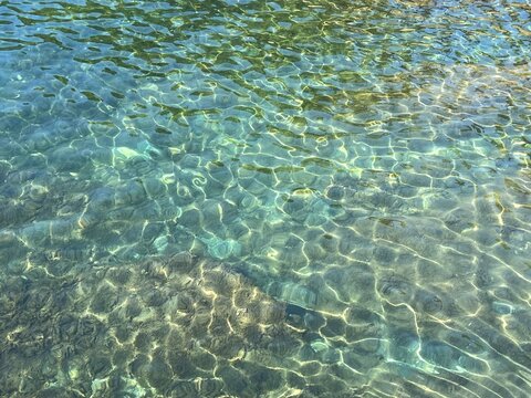 Sea rippled clear water with transparent surface