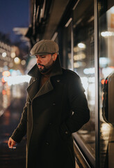 Busy businessman waiting for a cab on a rainy night in the city.