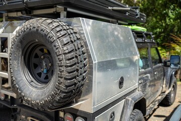 Camper trailer connected to a white car. SUV pulling a camper trailer with safety chains and wiring...