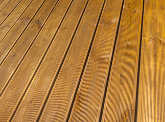 Siberian larch fluted wood terrace impregnated with oil before painting. Decking of wooden planks
