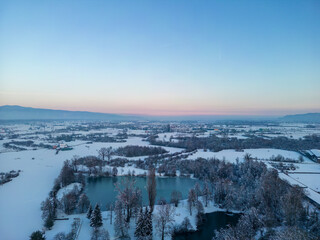 Aerial view of Bobovica lakes near Samobor, Croatia, covered in white snow and thick ice during winter season