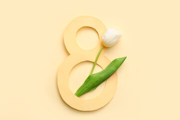 Figure 8 made of paper and beautiful white tulip on yellow background. International Women's Day