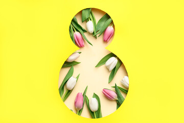 Cut paper in shape of figure 8 with beautiful tulips on yellow background. International Women's Day