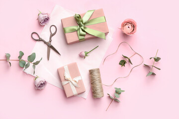 Gift boxes with wrapping paper and beautiful roses on pink background. International Women's Day